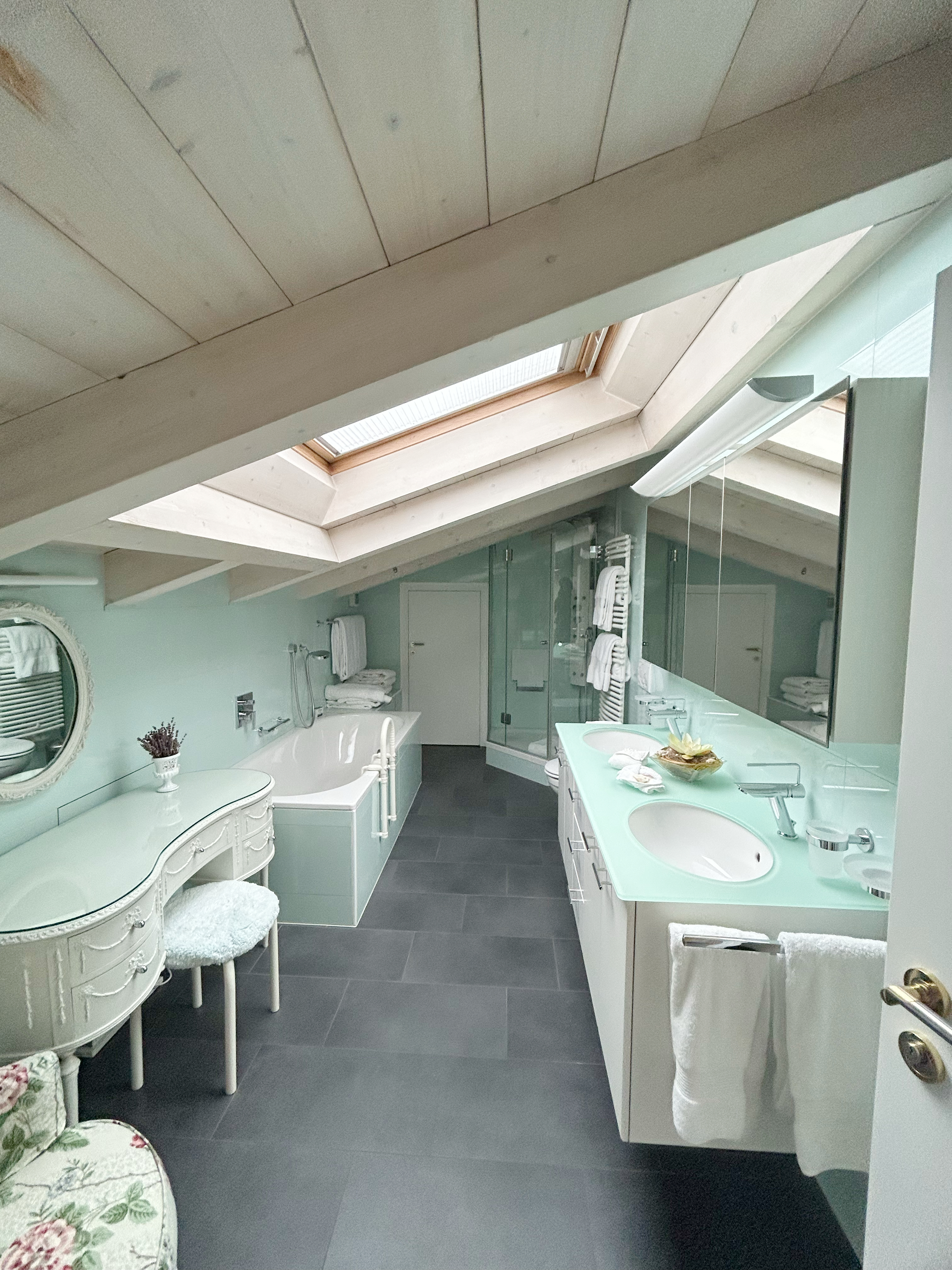 Helles Dachgeschoss-Badezimmer mit Doppelwaschtisch und Badewanne