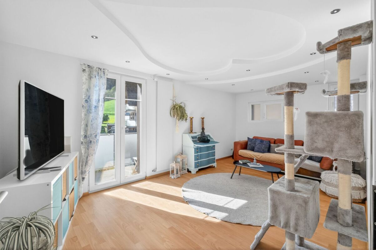 Helles Wohnzimmer mit Balkontür und Katzbaum