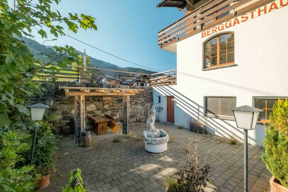 Außenhof mit Berghaus, Terrasse und Pergola