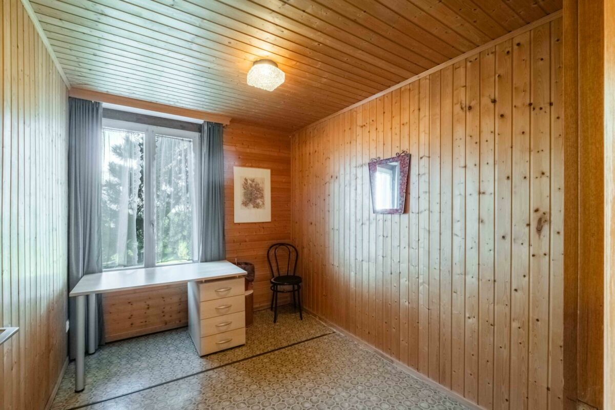 Holzvertäfelter Raum mit Fenster und Schreibtisch