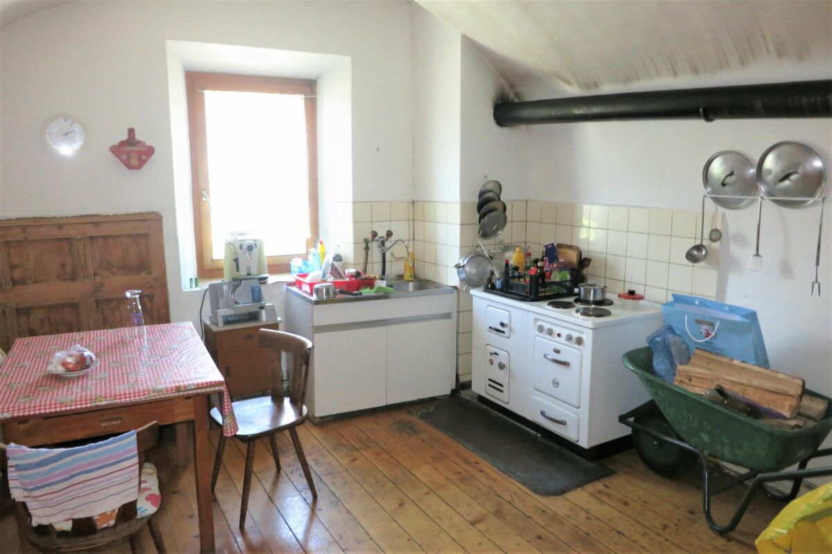 Rustikale Küche mit Holzofen und Esstisch