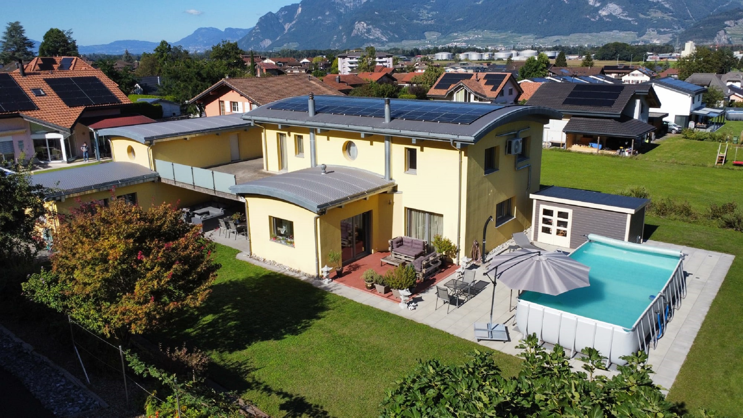 Drohnenaufnahme eines Hauses mit Pool und Garten