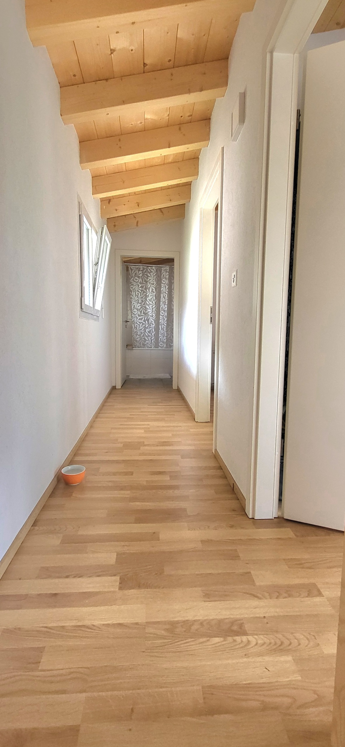 Heller Flur mit Holzbalkendecke