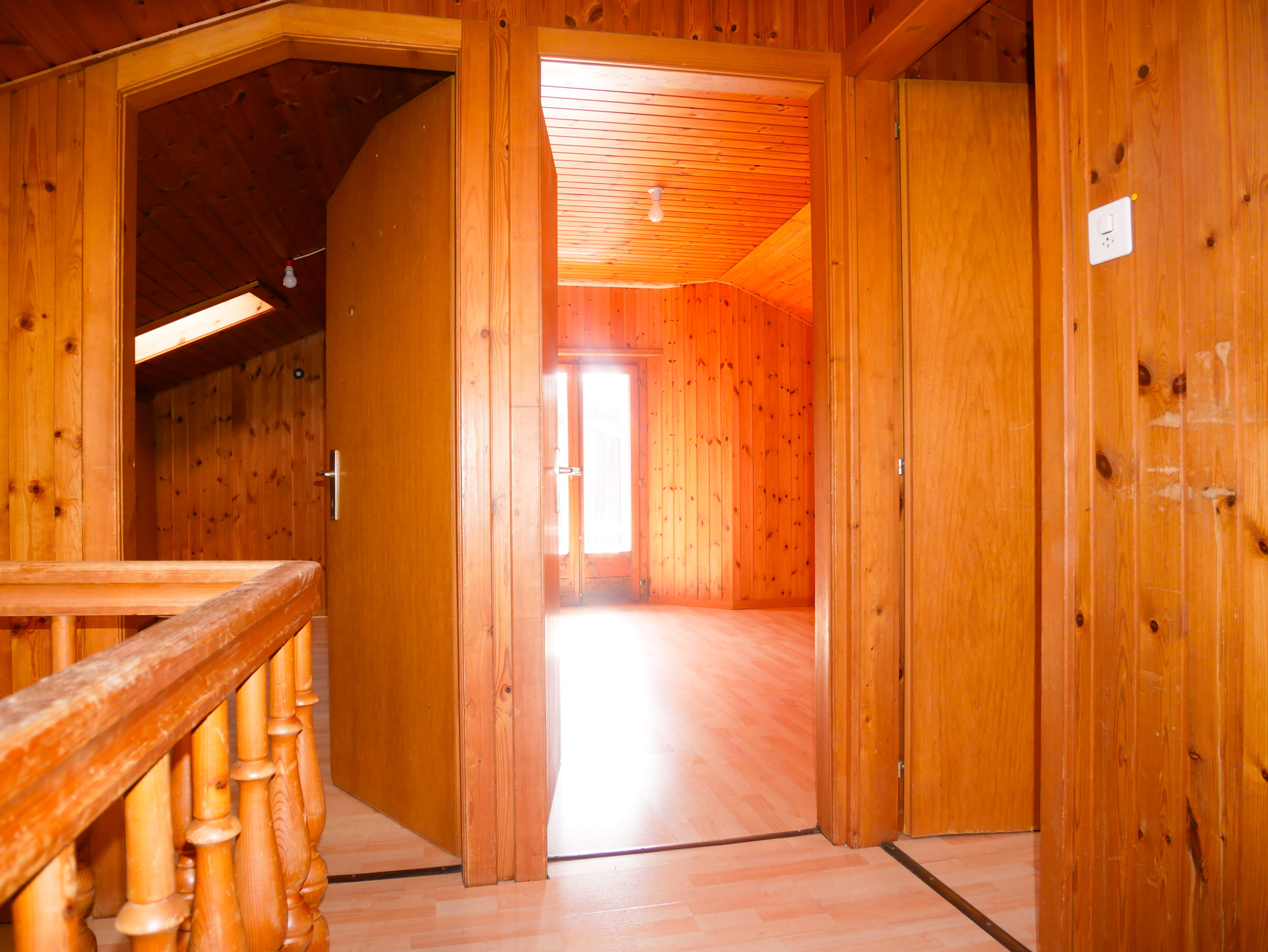 Holzvertäfelter Flur mit offenen Türdurchgängen