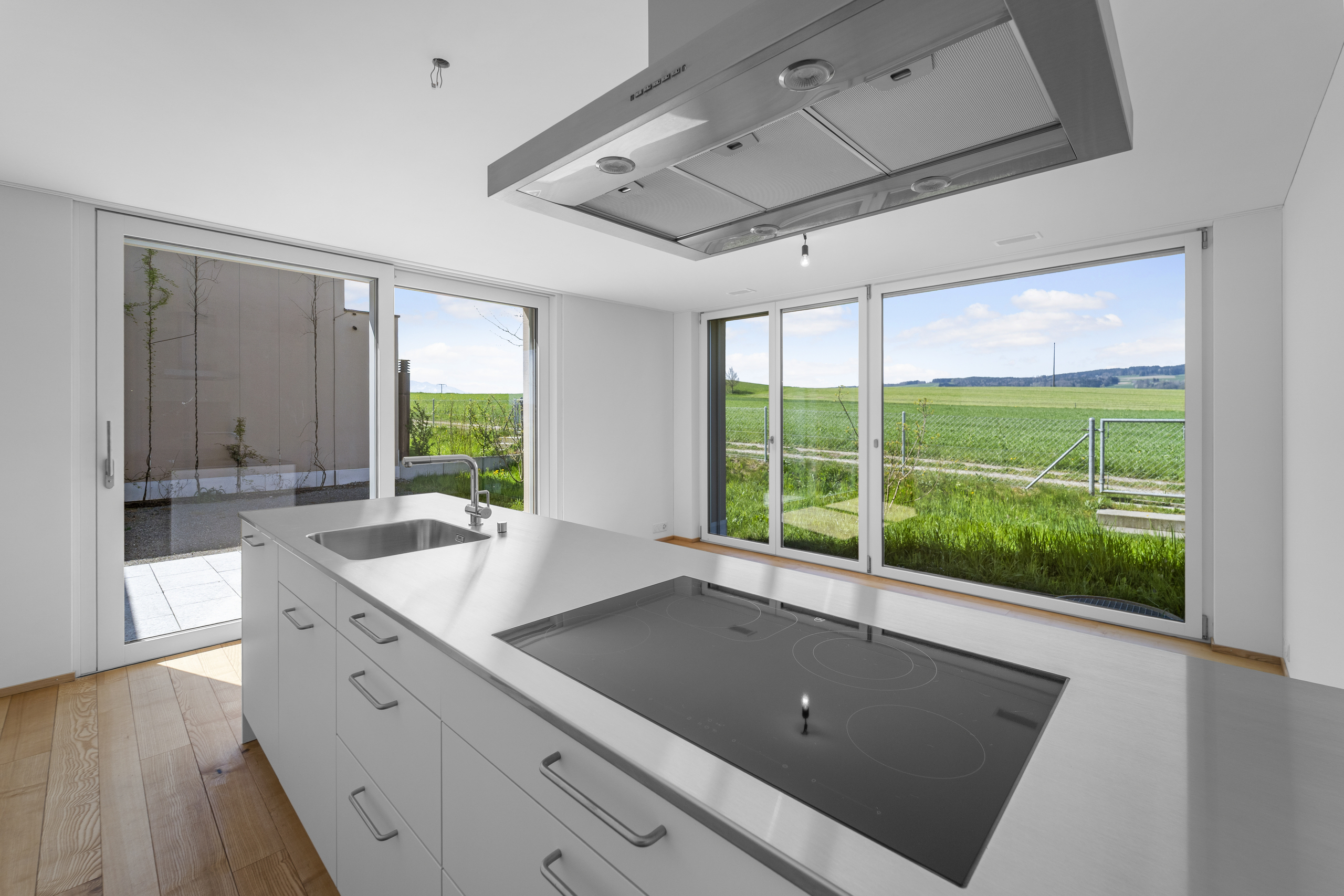Moderne Küche mit Insel und Landschaftsblick