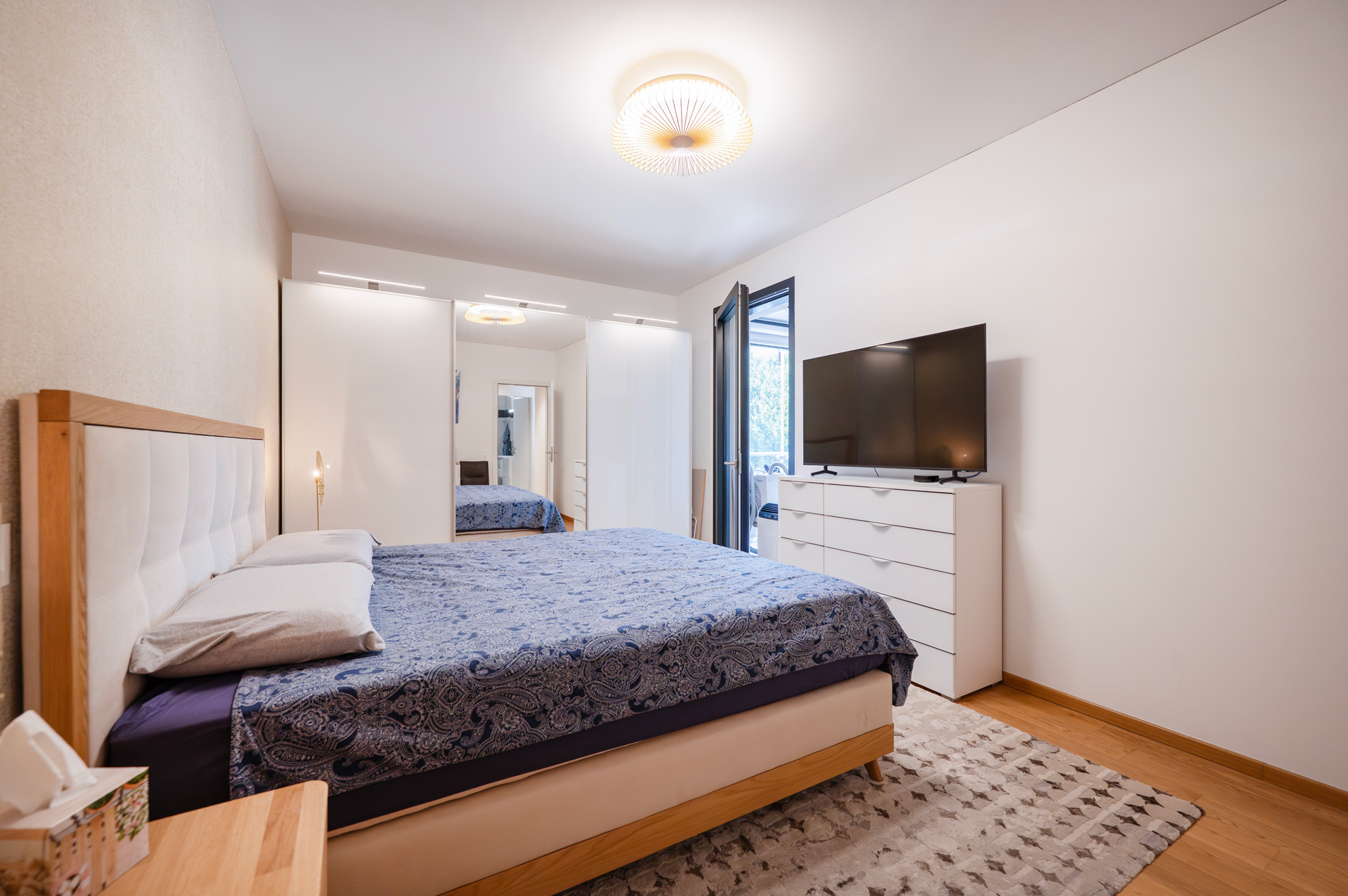 Helles Schlafzimmer mit Doppelbett und Kleiderschrank