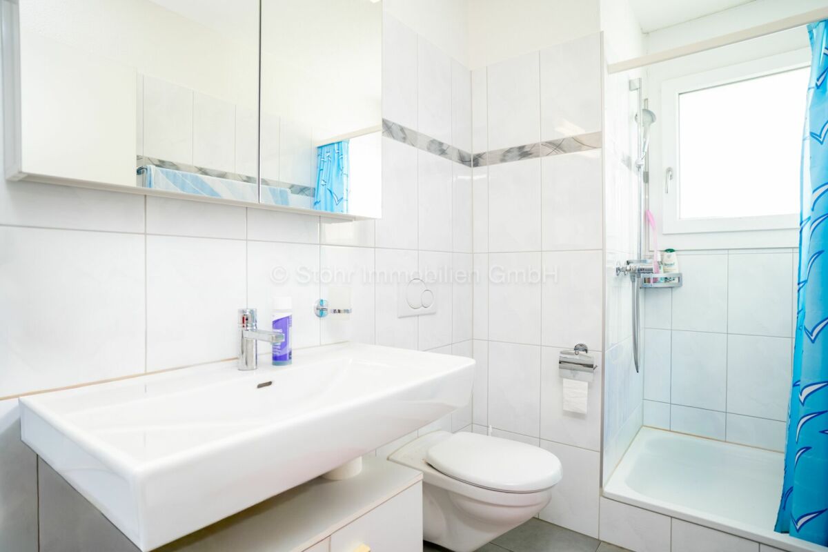 Helles Badezimmer mit Dusche und Waschtisch
