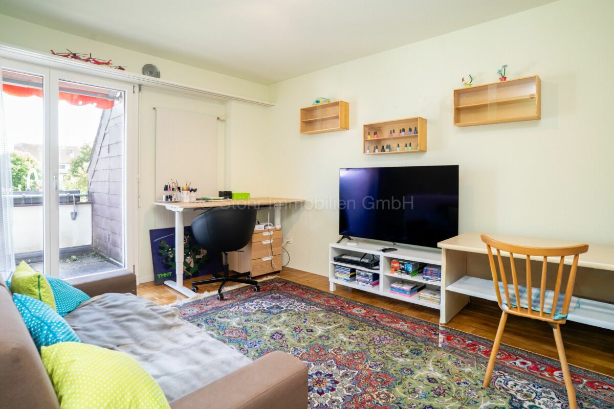 Helles Wohnzimmer mit Arbeits- und TV-Bereich