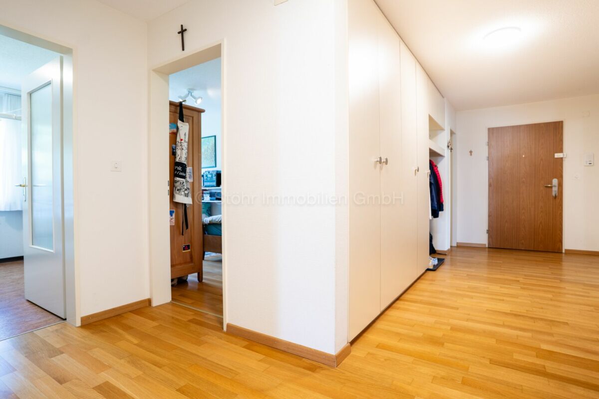 Heller Flur mit Einbauschränken und Holztür