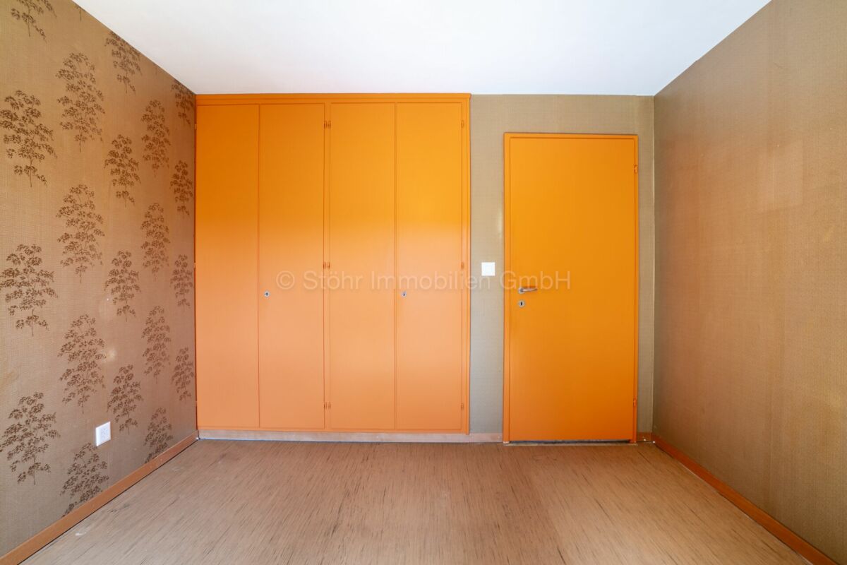 Kleiner Raum mit orangefarbenen Einbauten