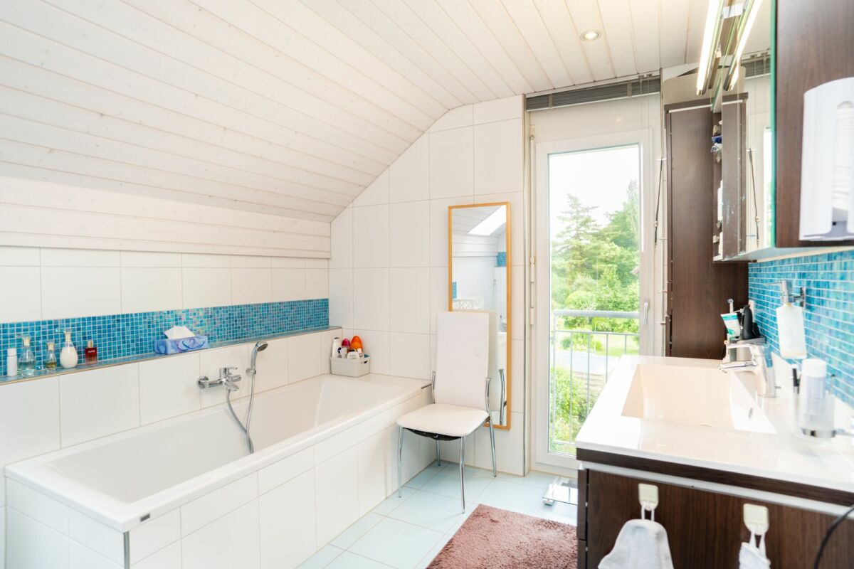 Modernes Badezimmer im Dachgeschoss mit Badewanne und Waschtisch