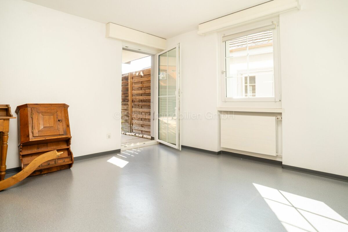 Heller leerer Raum mit Terrassentür und Fenster