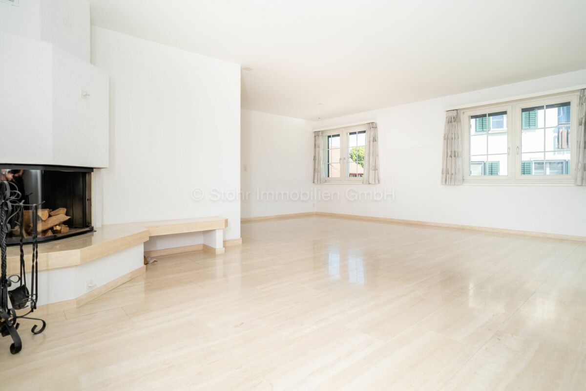 Heller Wohnraum mit Kamin und Parkettboden