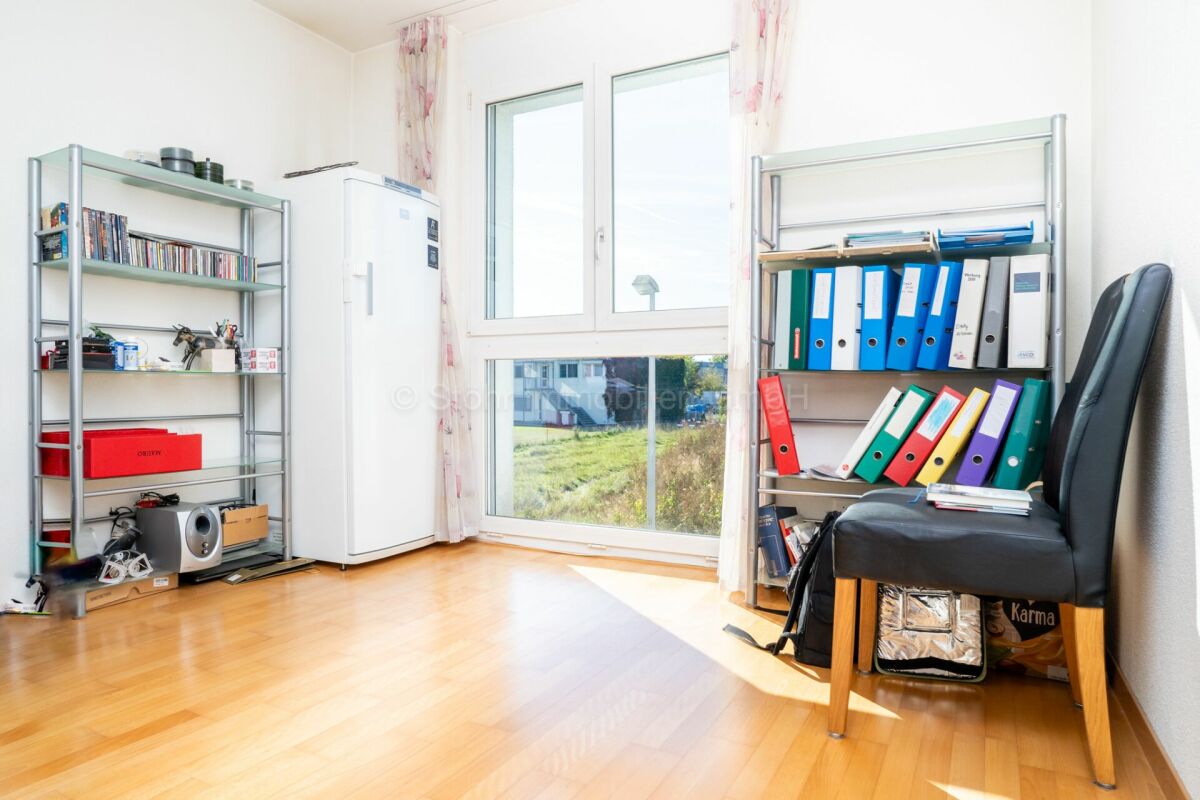 Helles Arbeitszimmer mit Regalen und Fenster