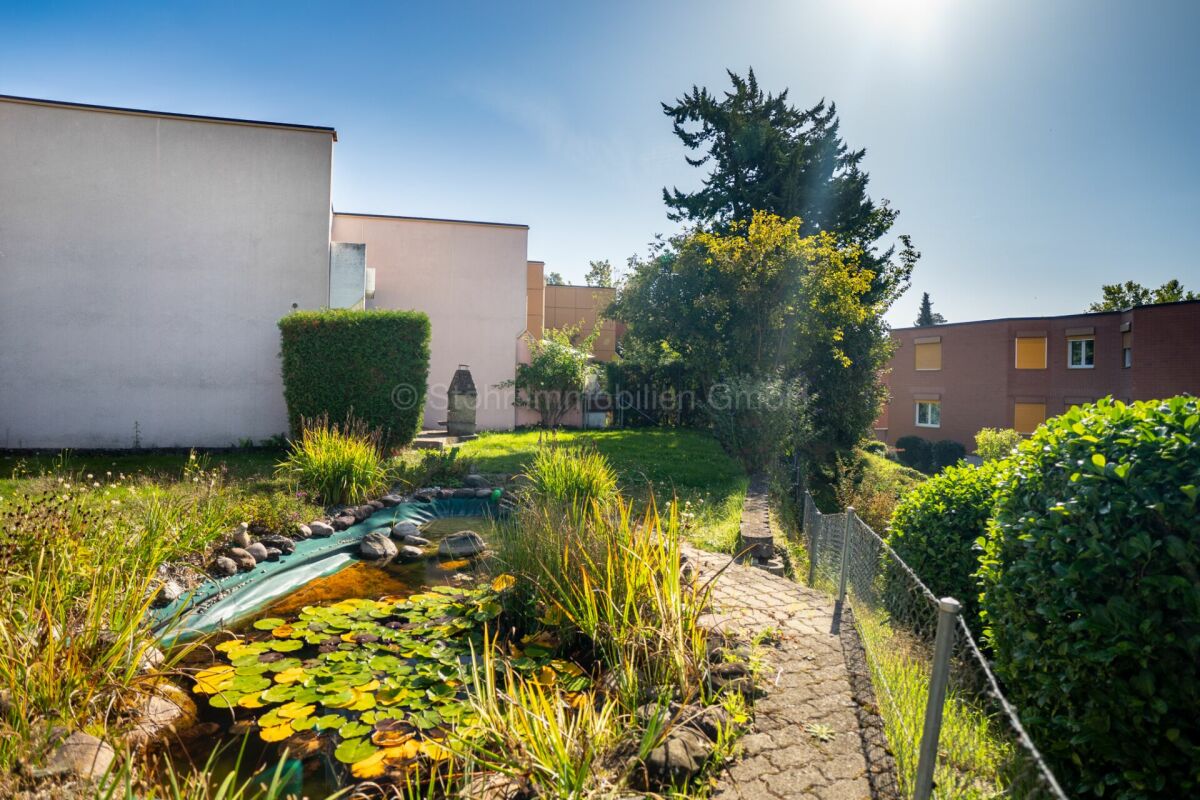 Gemeinschaftsgarten mit Teich und Wohnanlage