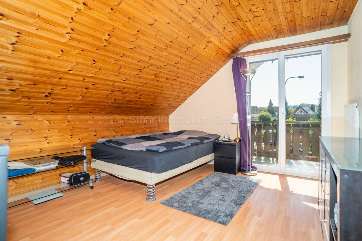 Dachgeschoss-Schlafzimmer mit Balkonzugang