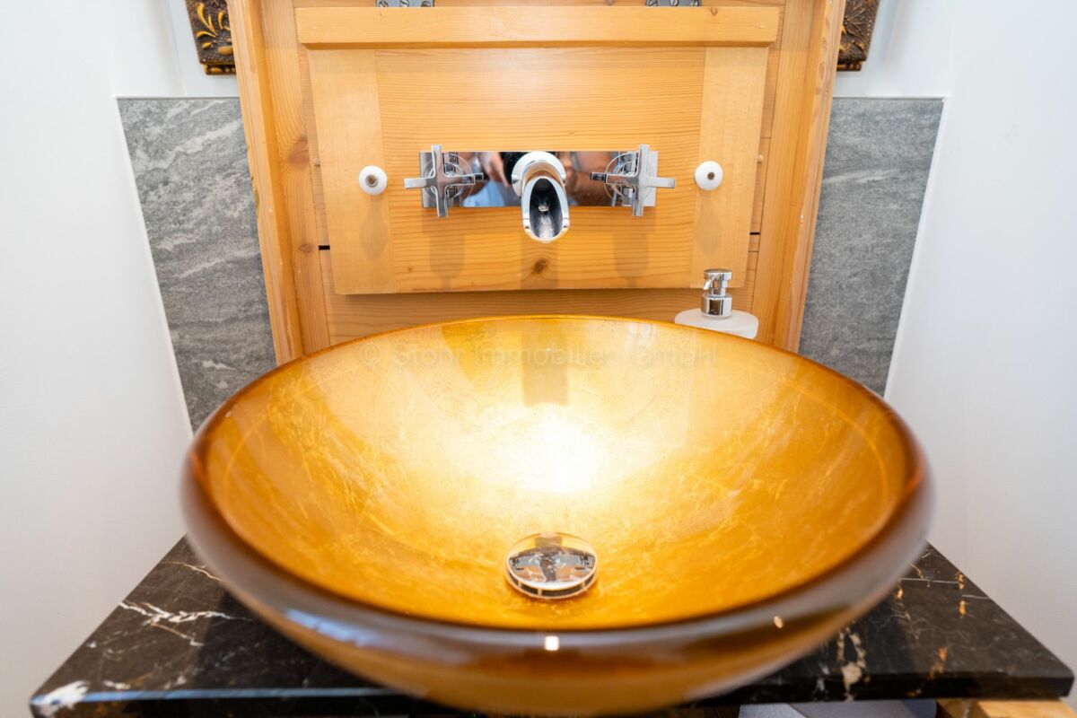 Luxuriöses Gäste-WC mit goldfarbener Aufsatzwaschbecken-Schale