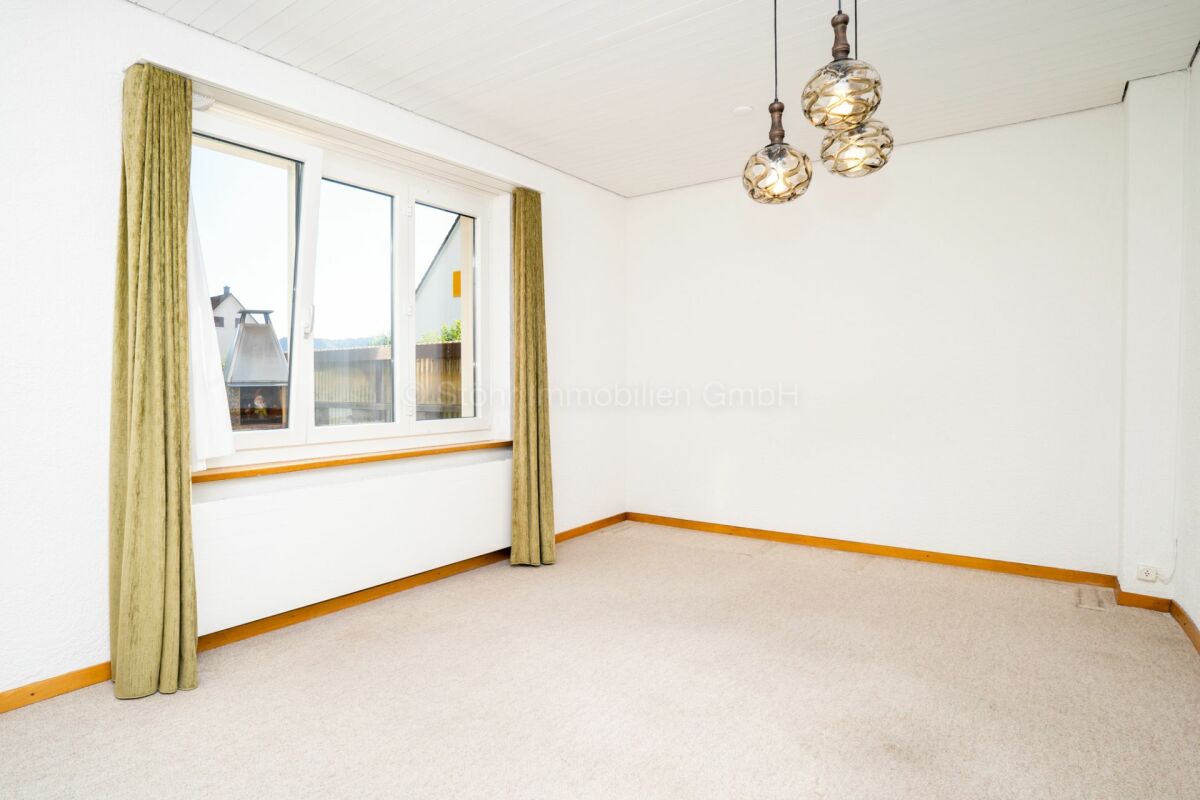Heller leerer Raum mit Fenster und Teppichboden