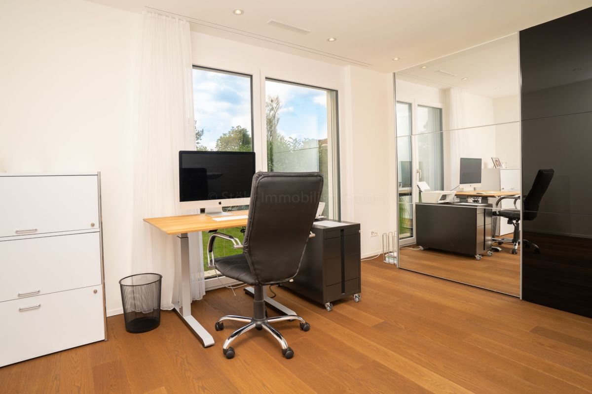 Modernes Homeoffice mit großem Spiegel und Tageslicht