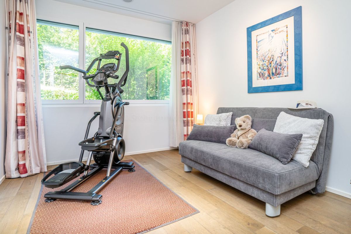 Heller Wohnraum mit Fitnessgerät und Sofa