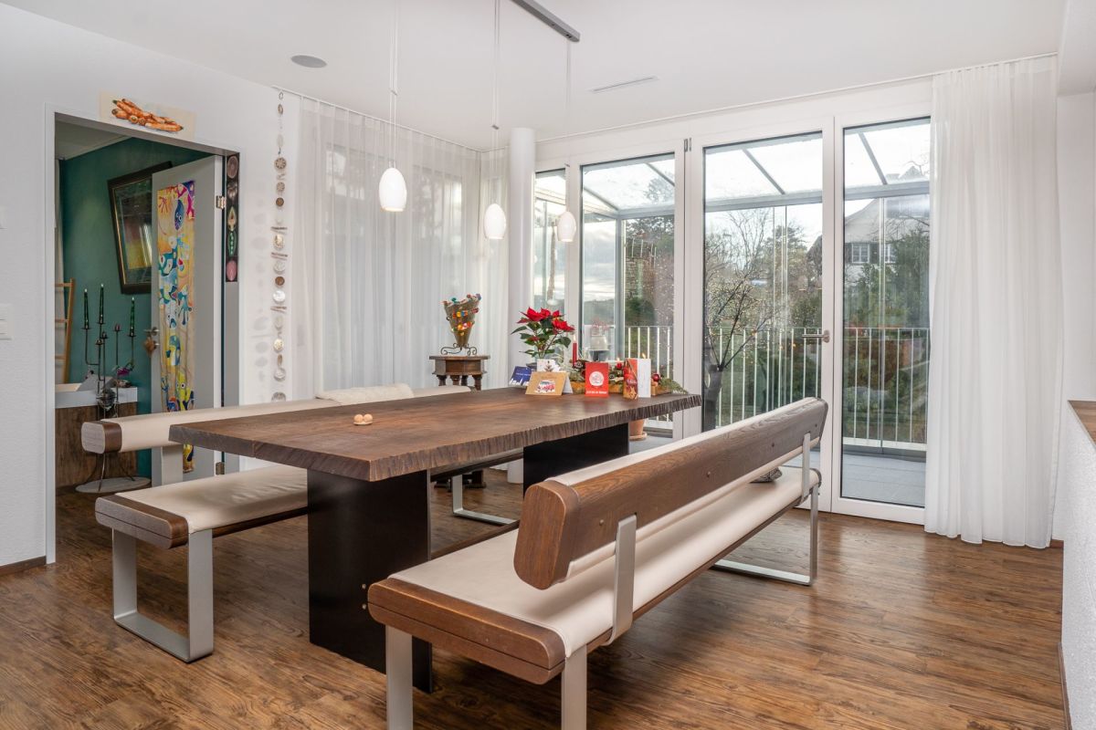 Esszimmer mit großer Fenstertür und Holztisch