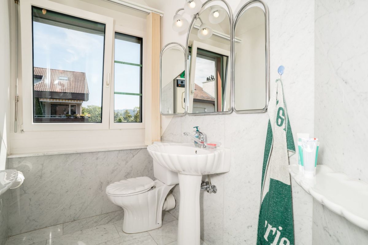 Helles Badezimmer mit Fenster und Waschbecken
