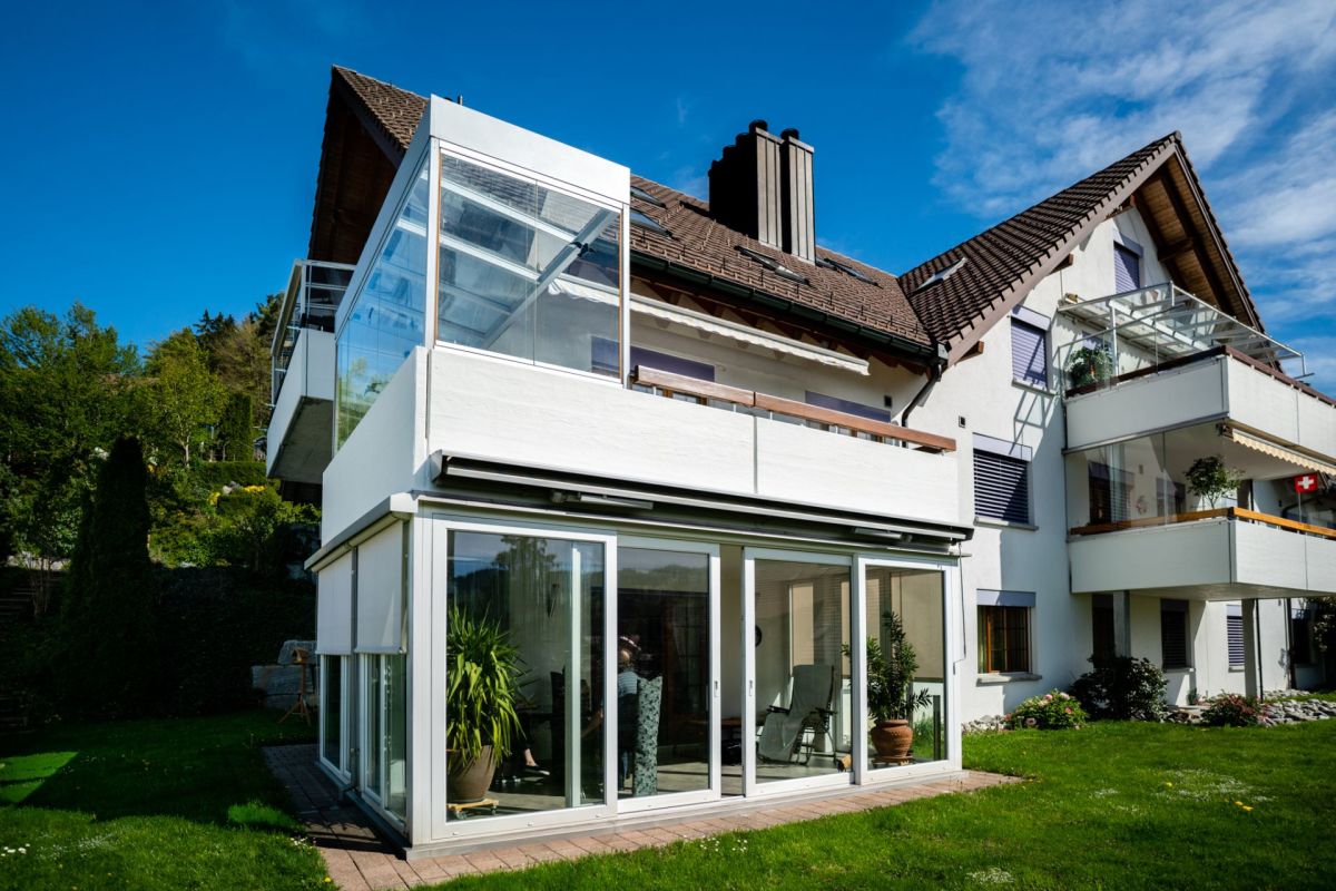 Wohnhaus mit verglasten Balkonen und Wintergarten