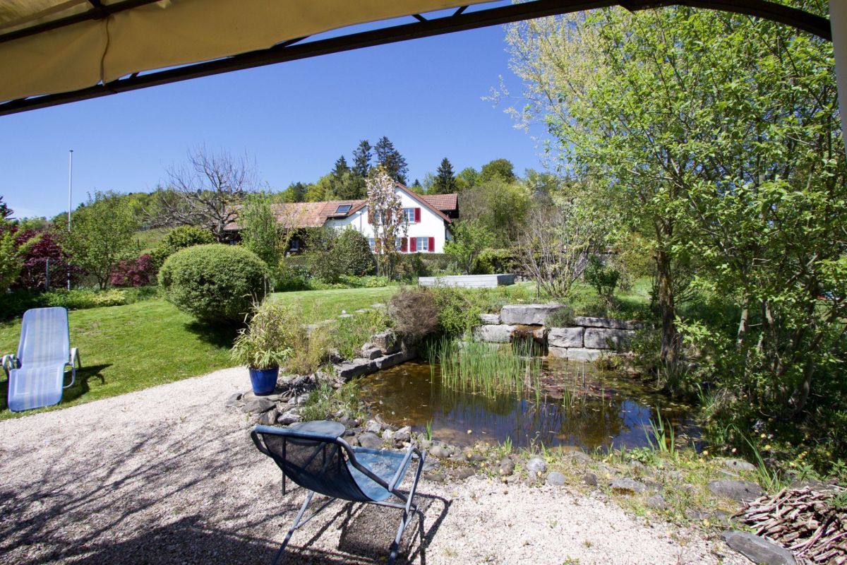 Garten mit Teich und Liegestuhl