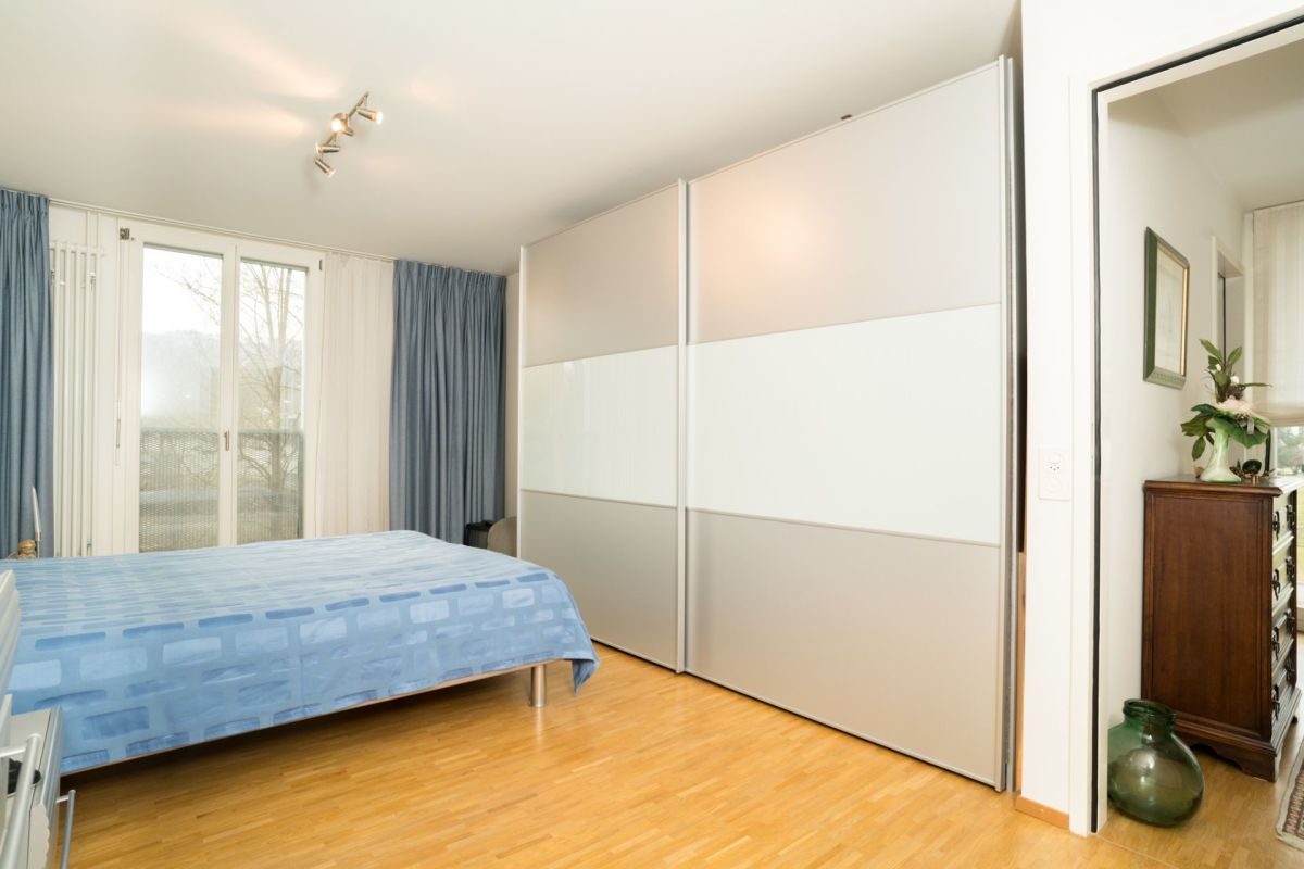 Schlafzimmer mit Einbauschrank und Balkontür