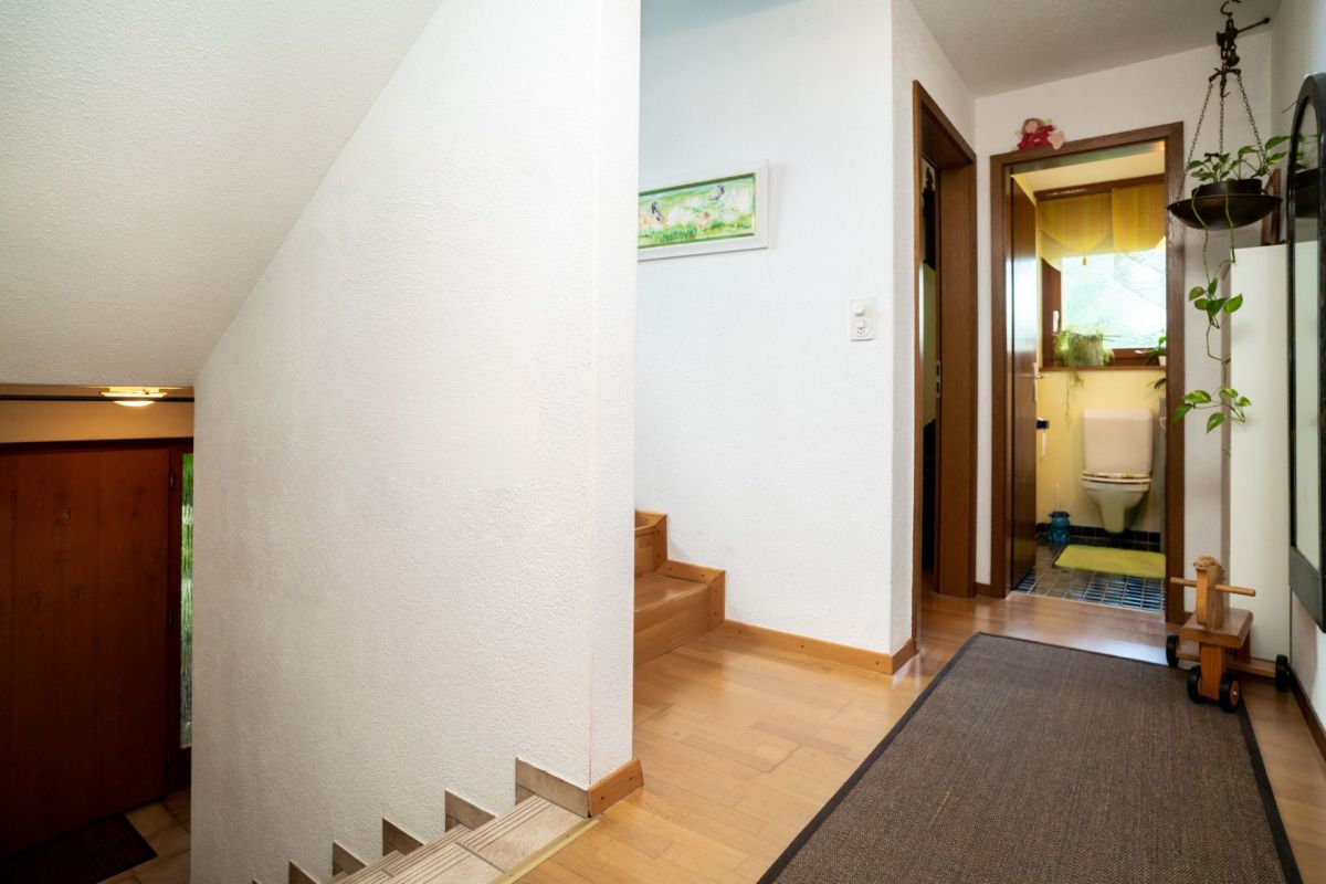 Heller Eingangsbereich mit Treppe und Gäste-WC