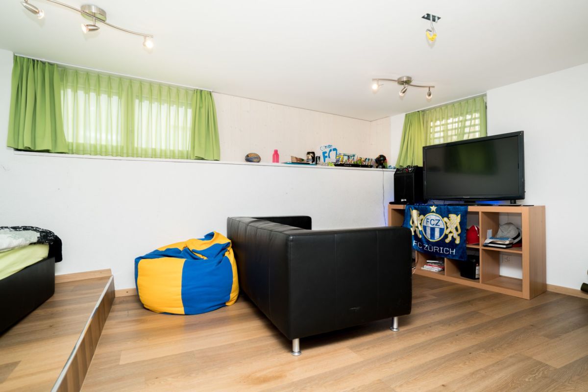 Gemütliches Wohn- bzw. Fernsehzimmer mit Dachfenstern und Sitzbereich