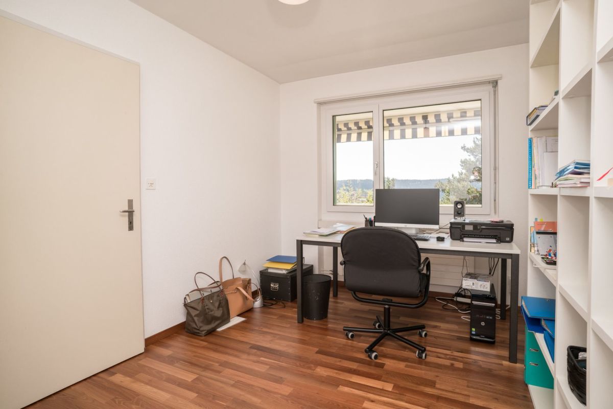 Arbeitszimmer mit Schreibtisch und Regalen