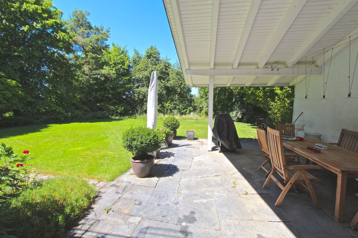 Überdachte Terrasse mit Gartenblick