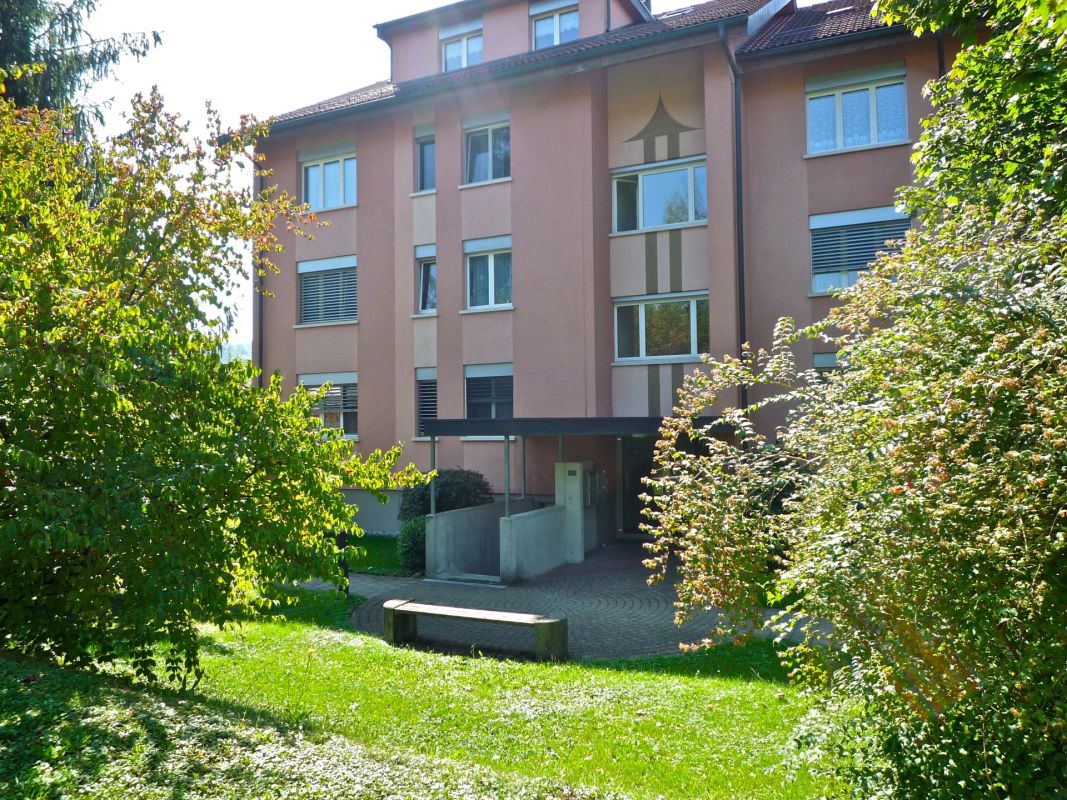 Mehrfamilienhaus mit grünem Vorgarten