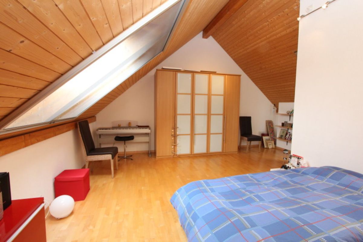 Dachgeschoss-Schlafzimmer mit Holzverkleidung