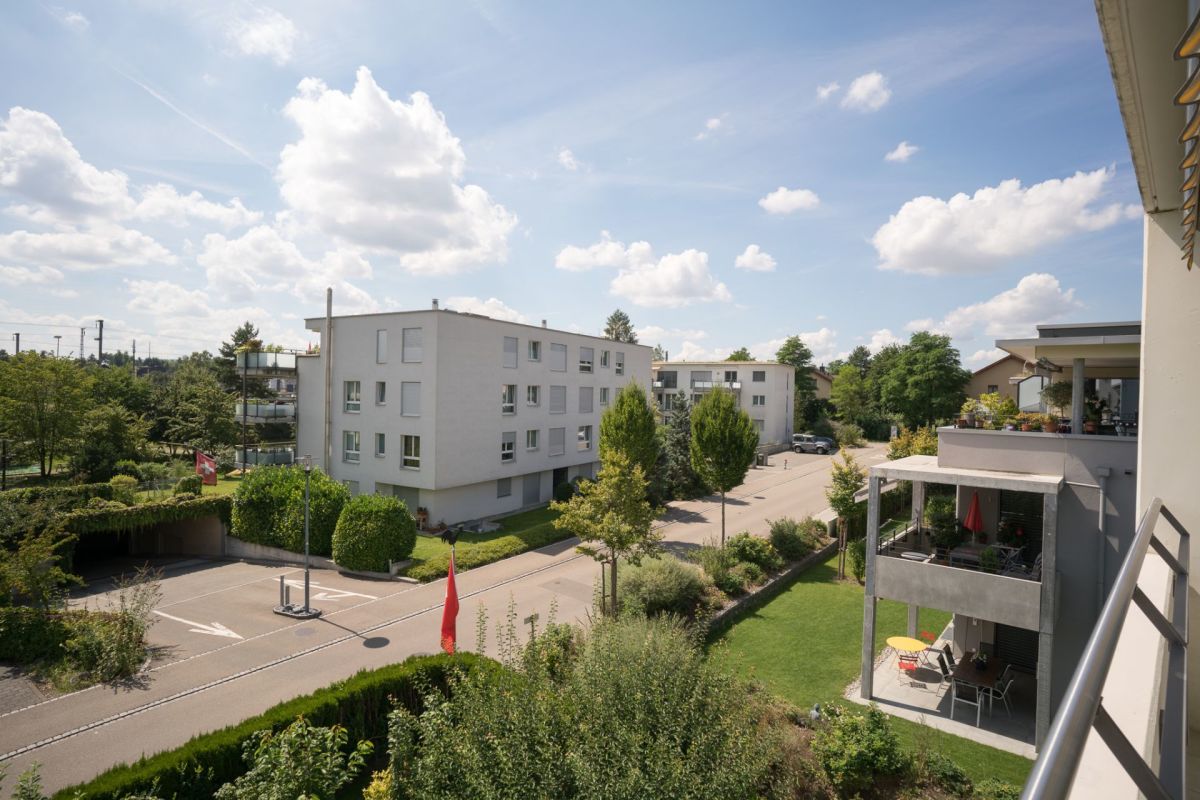Blick vom Balkon auf Wohnanlage und Grünanlage