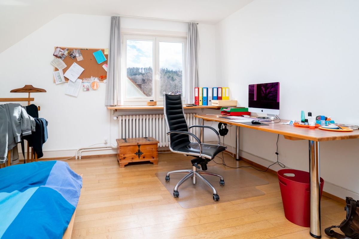 Arbeitszimmer mit Bett und Schreibtisch
