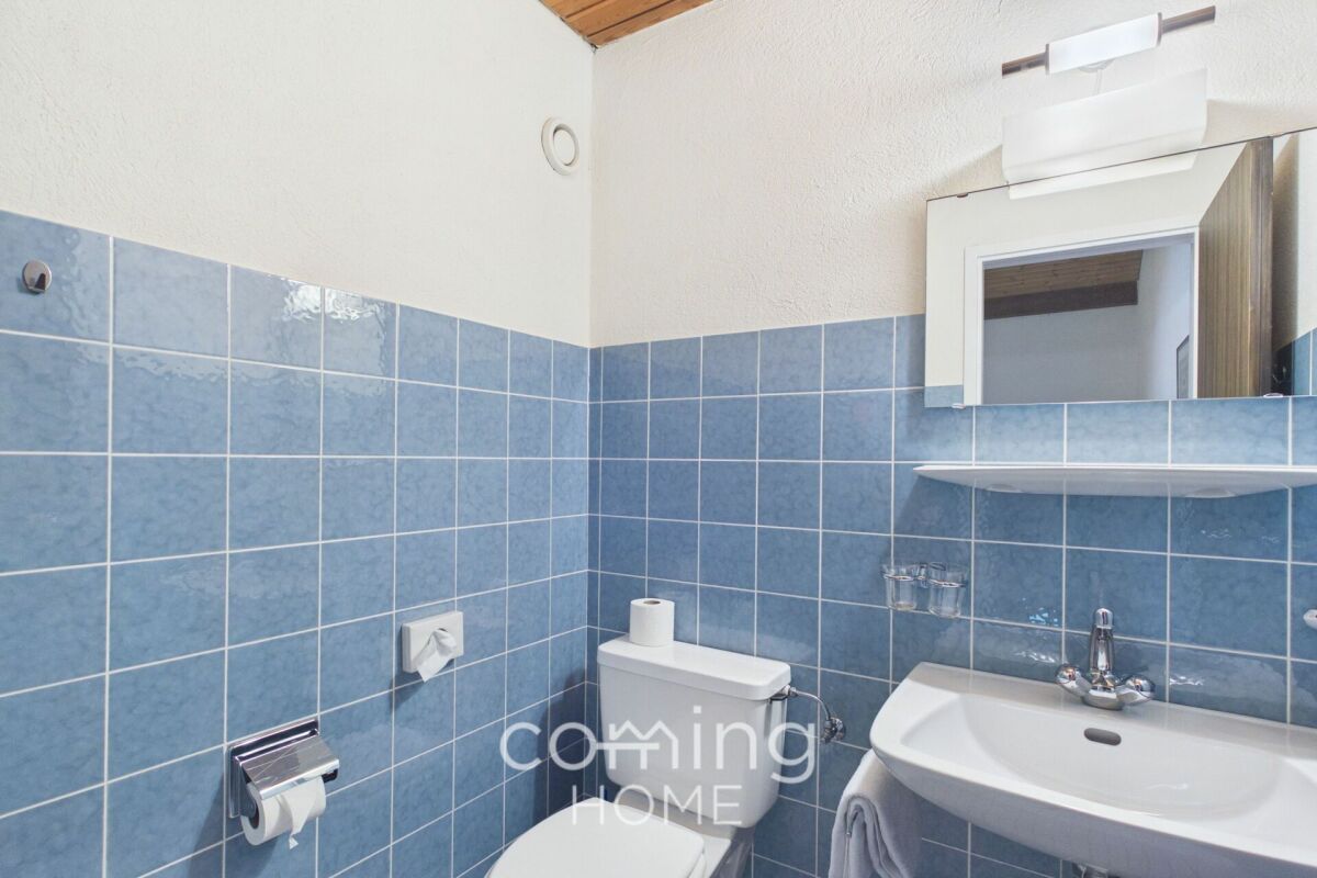 Kleines helles Badezimmer mit blau gefliesten Wänden