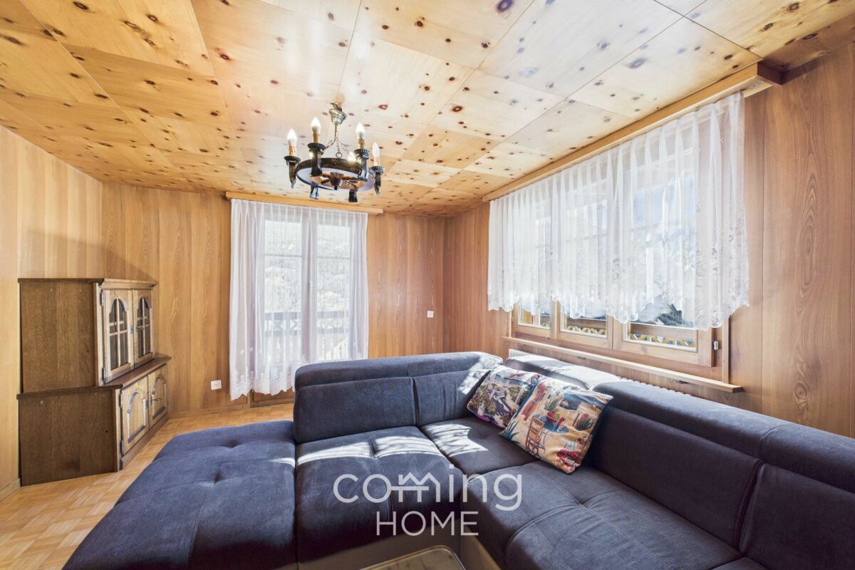 Wohnzimmer in Holzoptik mit dunkelgrauer Eckcouch