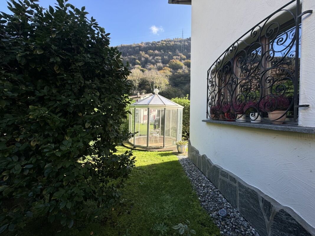 Gartenansicht mit Hauswand und Pavillon