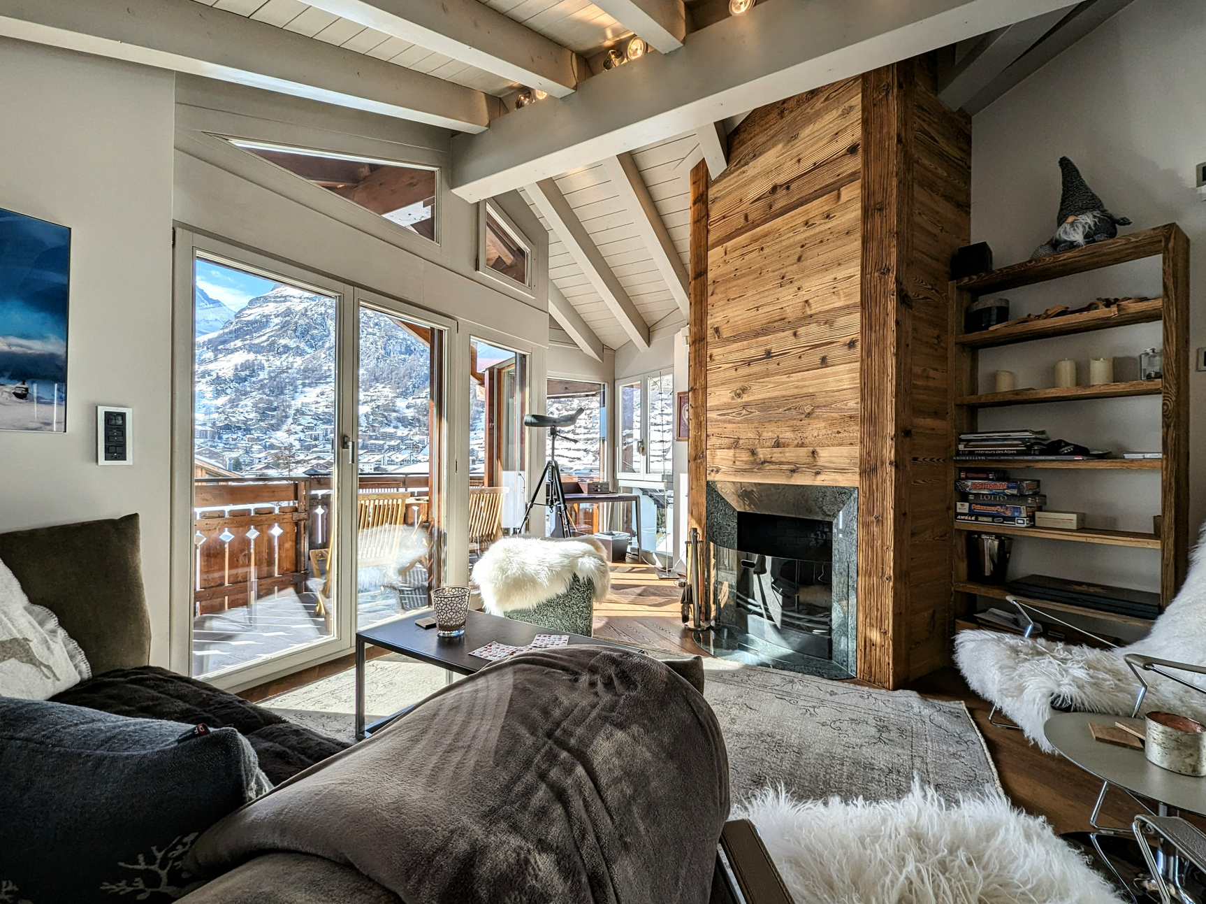 Gemütliches Wohnzimmer mit Kamin und Bergblick