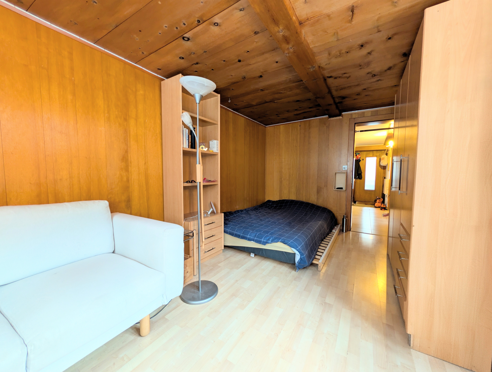 Gemütliches Schlafzimmer mit Holzverkleidung