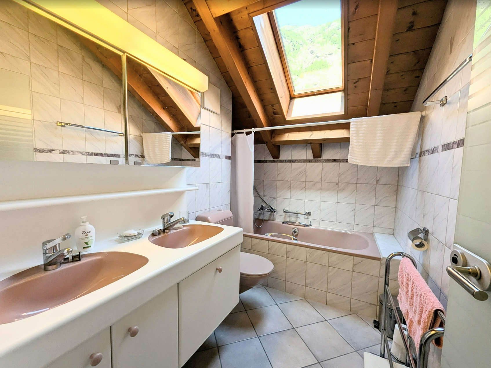 Dachgeschoss-Badezimmer mit Badewanne und Doppelwaschbecken