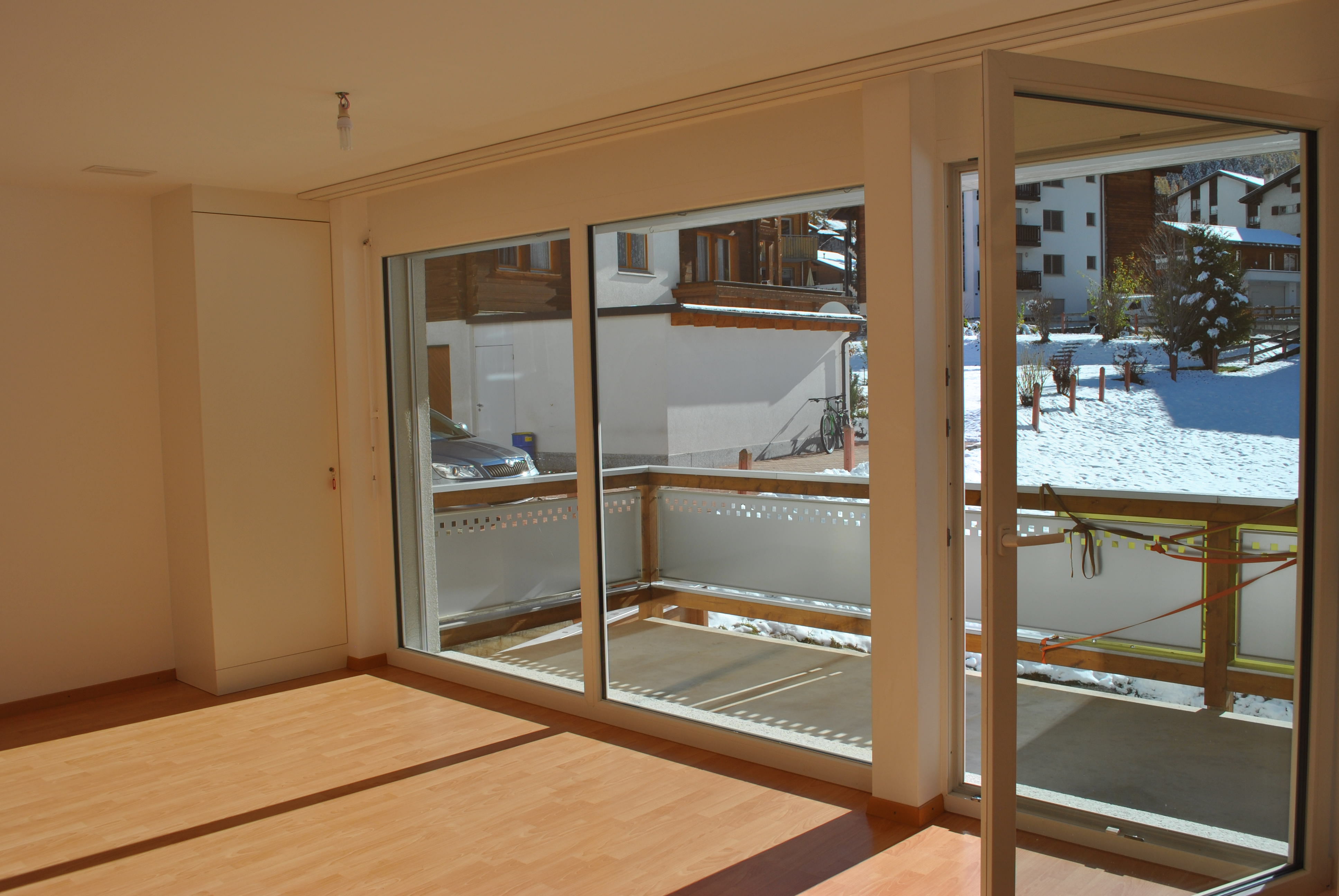 Heller Wohnraum mit Balkon und großen Fenstern
