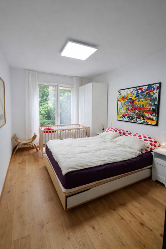 Helles Schlafzimmer mit großem Bett und Fenster