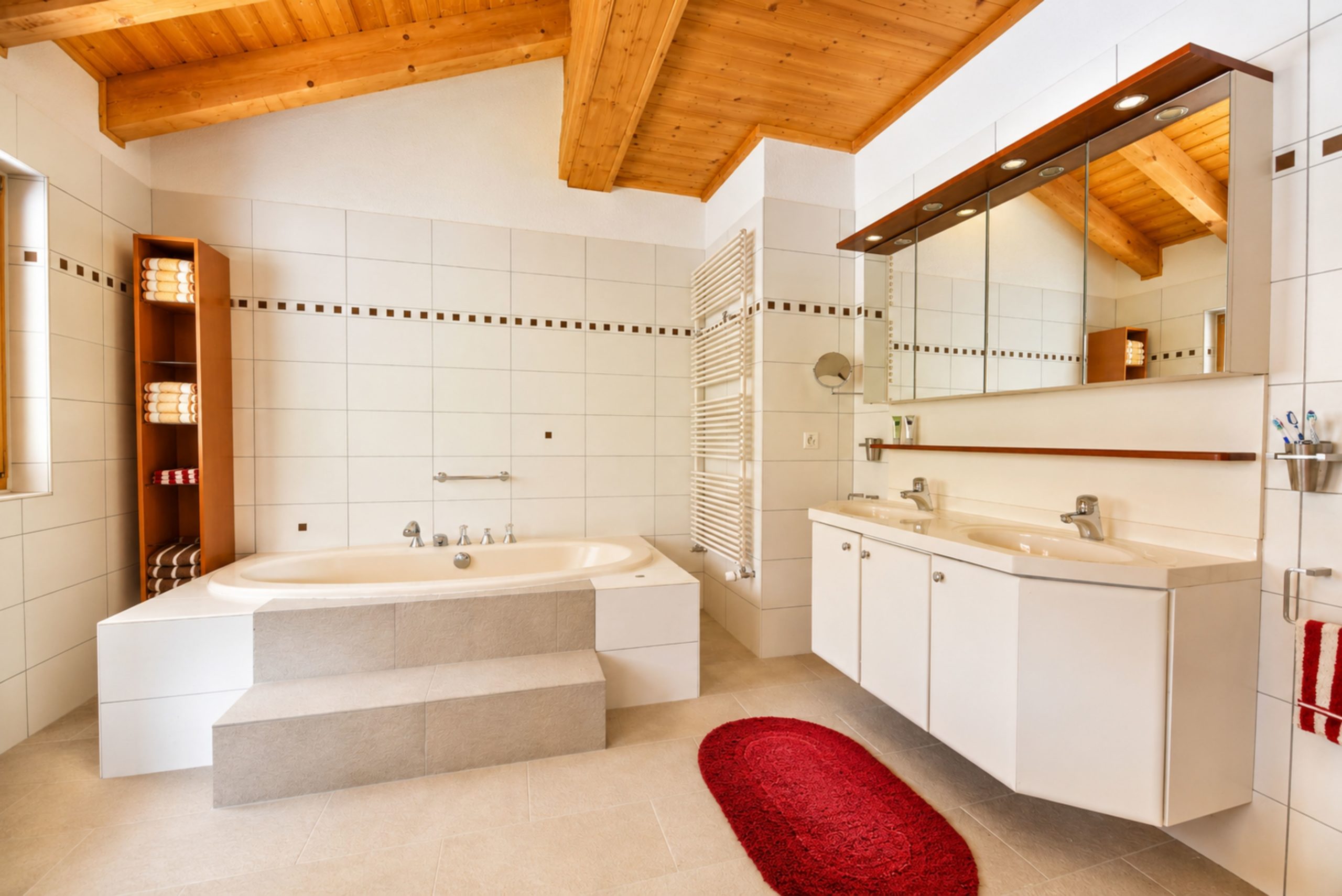Helles Badezimmer mit Holzdecke und Doppelwaschtisch