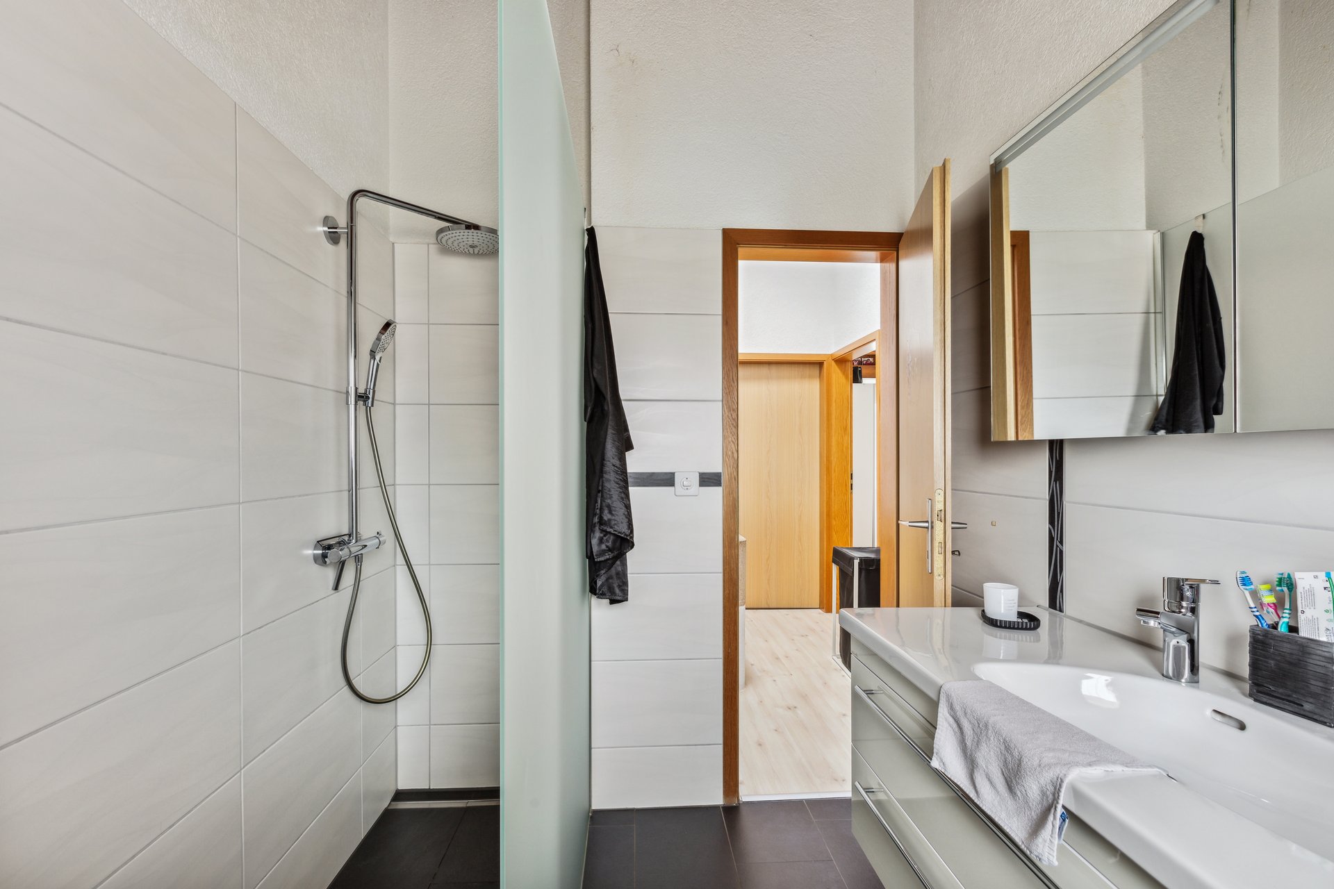 Modernes Badezimmer mit Dusche und Waschplatz