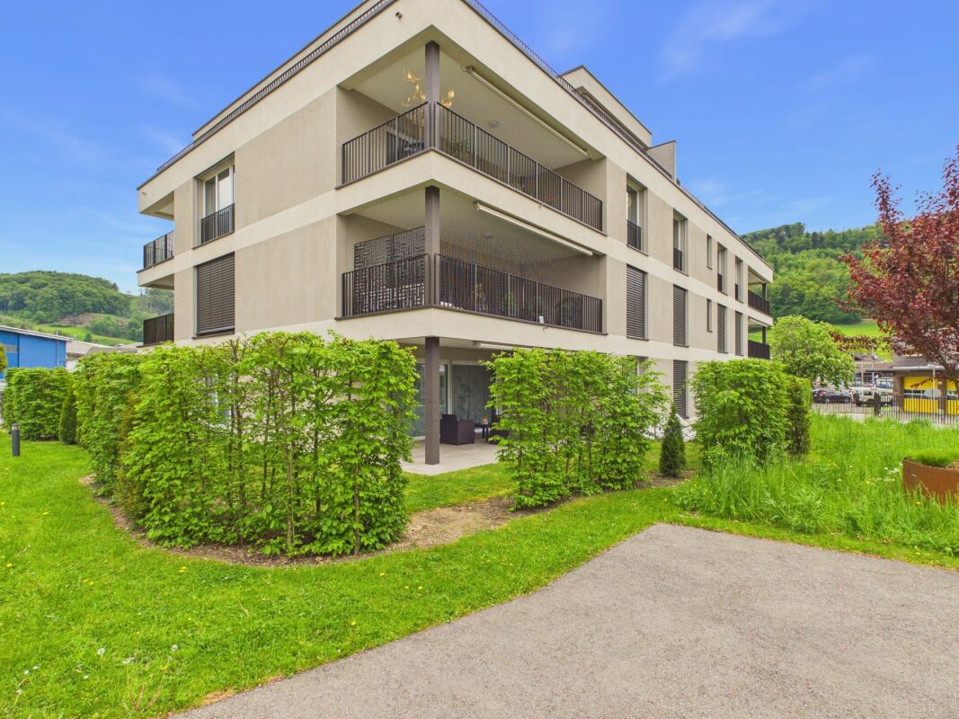 Mehrfamilienhaus mit Balkonen und gepflegter Umgebung