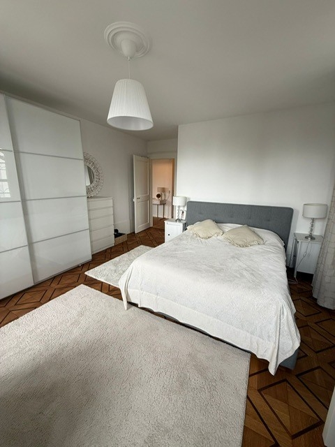 Helles Schlafzimmer mit großem Bett und weißem Kleiderschrank