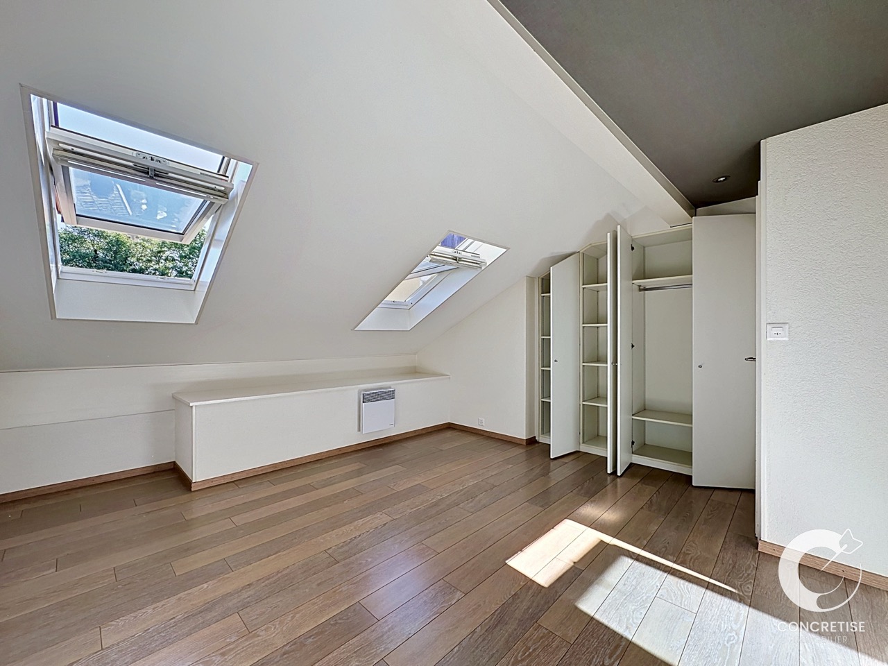 Dachgeschosszimmer mit Dachfenstern und Einbauschrank